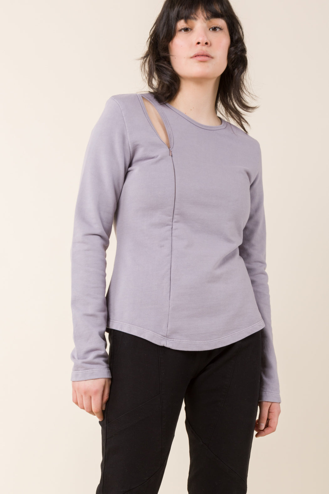 The Tendril Sweater employs multiple necklines to appear as layers, exposing the clavicle. The softness and ease of a sweatshirt with a minimal, futuristic appearance.