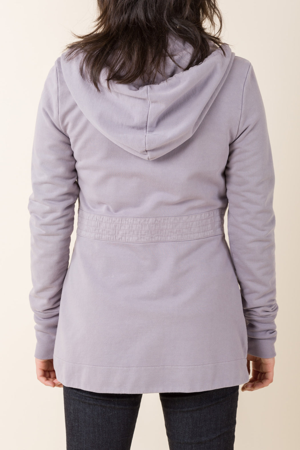 Our Madame X Hoodie is a mid-length hoodie featuring a quilted woven overlay, back belt, with fit and flare shaping and a cinched waist, composed of 100% organic cotton. 