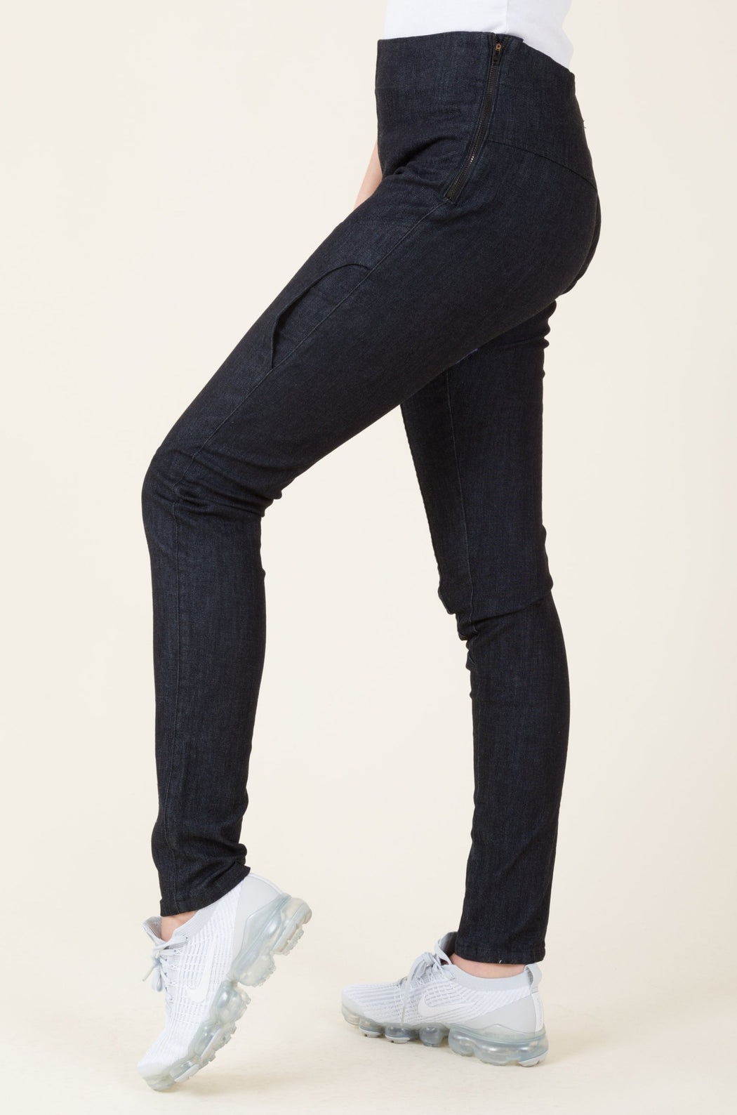 A mid-rise, skinny legged denim legging (or jegging), with elliptical pockets on the thigh and a long inseam.