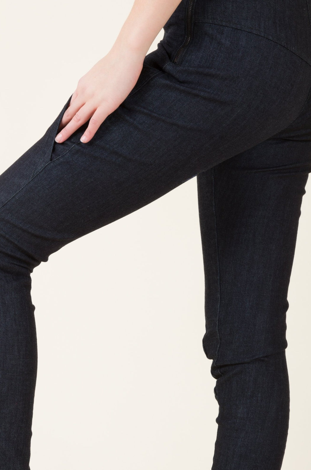 A mid-rise, skinny legged denim legging (or jegging), with elliptical pockets on the thigh and a long inseam.