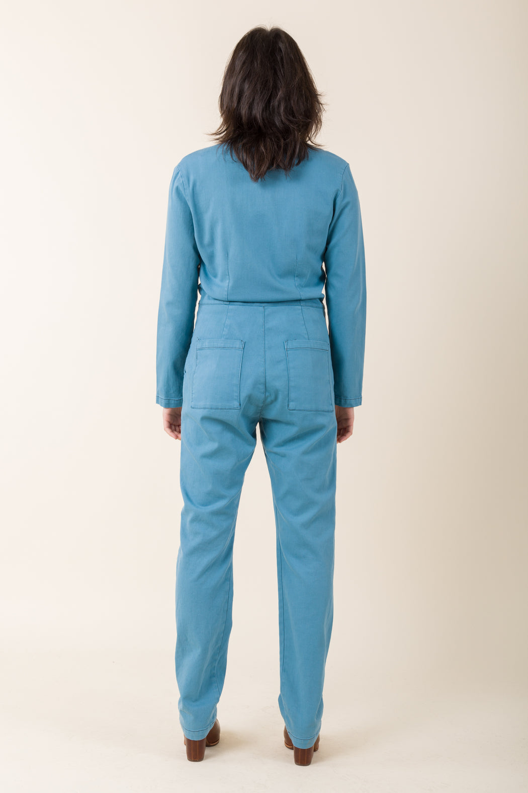 This version of our Denim Coveralls is nipped and darted with a high waist and fitted hip. Bulletproof luxury that is ready for anything, we stripped back details to create the perfect basic coverall.