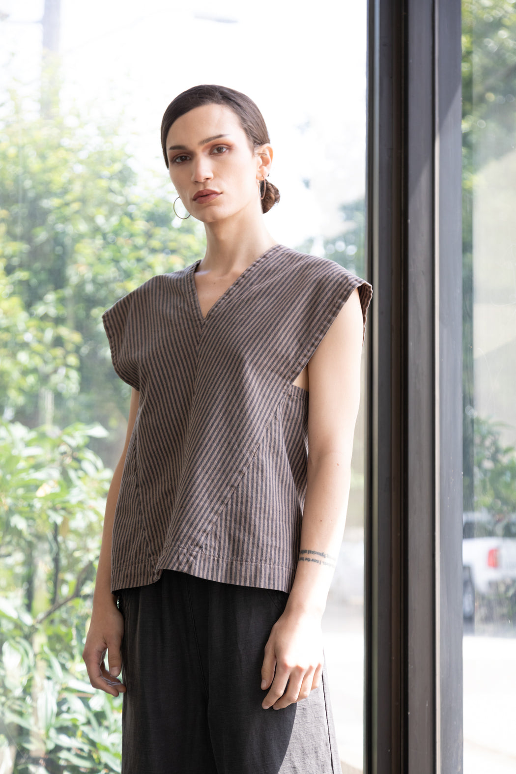 Photo of A-line striped, sleeveless shirt with a loose fit.